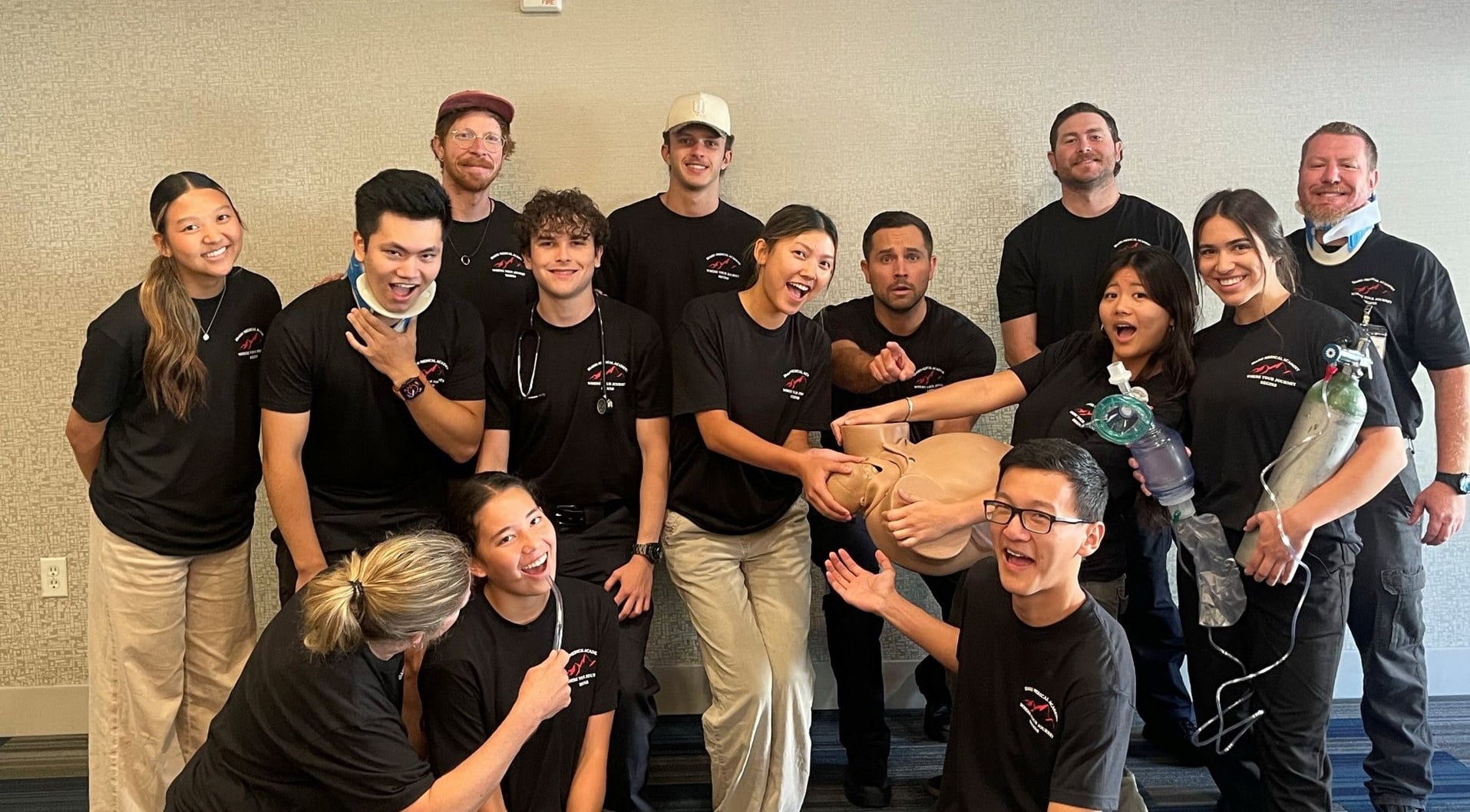 Idaho Medical Academy self-paced EMT course students with a CPR manikin, bag valve mask, and oxygen cylinder